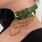 Green leather choker with gold chain and buckle worn by a person