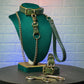 Green leather bondage collar, leash, and handcuffs on a green mannequin bust against a textured blue wall.