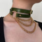 Green leather choker with gold chain necklace on a person against a neutral background