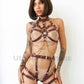 Leather open bust harness and chain loops paired with a crotchless leather garter belt. Photo on female model. Marsala leather, gold hardware. Front view.