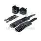 Black leather handcuffs and ankle cuffs with two connectors and carabiners. One handcuff and ankle cuff clasped, the other unclasped to show the difference in length. Dark nickel hardware.