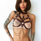 Breast harnesses with open bust and chains. Front view on model. Demonstrates how the harness will sit on the body. Gold hardware, Marsala leather.