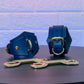 Blue leather handcuffs and leads on a dark surface with a light blue tiled wall background.