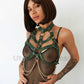 Breast harnesses with open bust and chains. Front view on model. Demonstrates how the harness will sit on the body. Gold hardware, green leather.