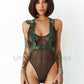 Wide chest harnesses with D-rings for attaching handcuffs or other accessories. Front view of the model. Demonstrates how the harness will sit on the body. Gold hardware, green leather.
