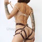 Leather belt with garters. Back view on model shows how the harness emphasizes the buttocks. Demonstrates how the belt will sit on the body. Gold hardware, marsala leather.