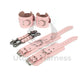 Pink leather handcuffs and ankle cuffs with two connectors and carabiners. One handcuff and ankle cuff clasped, the other unclasped to show the difference in length. Dark nickel hardware.