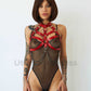Breast harnesses with open bust and chains. Front view on model. Demonstrates how the harness will sit on the body. Dark nickel hardware, red leather.