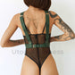 Wide chest straps with D-rings for attaching handcuffs or other accessories. Back view of the model. The harness is worn backwards and is versatile. Gold hardware, green leather.