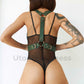 Wide chest harnesses with D-rings for attaching handcuffs or other accessories. Back view of the model. Demonstrates how the harness will sit on the body. Gold hardware, green leather.