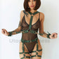 Wide chest harness with bondage garters with handcuffs attached to the garters with D-rings. The handcuffs are fastened to the D-Rings on the chest harness. Front view. Green leather. Gold hardware.