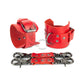 Red leather handcuffs with two connectors and carabiners lie side by side, one handcuff is shown from the side of the buckle and lies half sideways the second handcuff stands half sideways and is shown from the side of the D-ring for which the carabiner is fixed. Dark nickel hardware. 