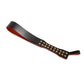 Handmade Loop Core leather paddle displayed flat on a white background. The image shows the distinctive loop construction, decorative metal studs, and the narrow striking profile of the paddle.