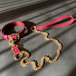 Marsala collar and leash with gold chain and marsala handle on a gray background