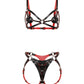 Front view of a reversible leather harness bra and matching strap-on harness crafted from black and red dual-color leather. The contour bra includes removable leather nipple covers attached with adjustable Chicago screws, allowing the coverage pieces to be repositioned or removed entirely while preserving the harness design. The matching front strap-on harness features a large triangular center panel with adjustable leather straps and movable metal rings for compatibility with different strap-on ring sizes.
