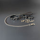 Set of black leather collar, handcuffs and leash with silver hardware on a gray background