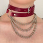 Marsala leather choker with metal chain necklace on a plain background