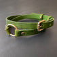 Green leather choker with gold buckle on a gray background