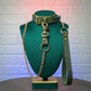Green leather collar and leash set on a mannequin bust against a textured white wall.