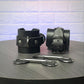Black leather cuffs with metal buckles on a wooden surface