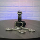 Black leather handcuffs with silver hardware on a wooden surface
