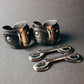 Pair of leather cuffs on a dark gray background