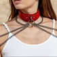 Woman wearing a red leather choker necklaces against a beige stone wall.
