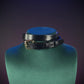 Black leather choker with a gold buckle.