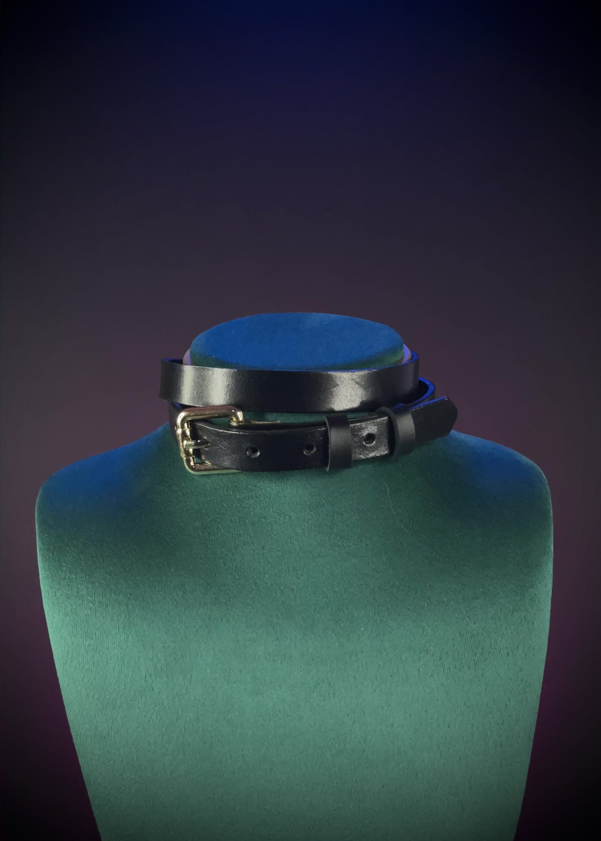Black leather choker with a gold buckle.