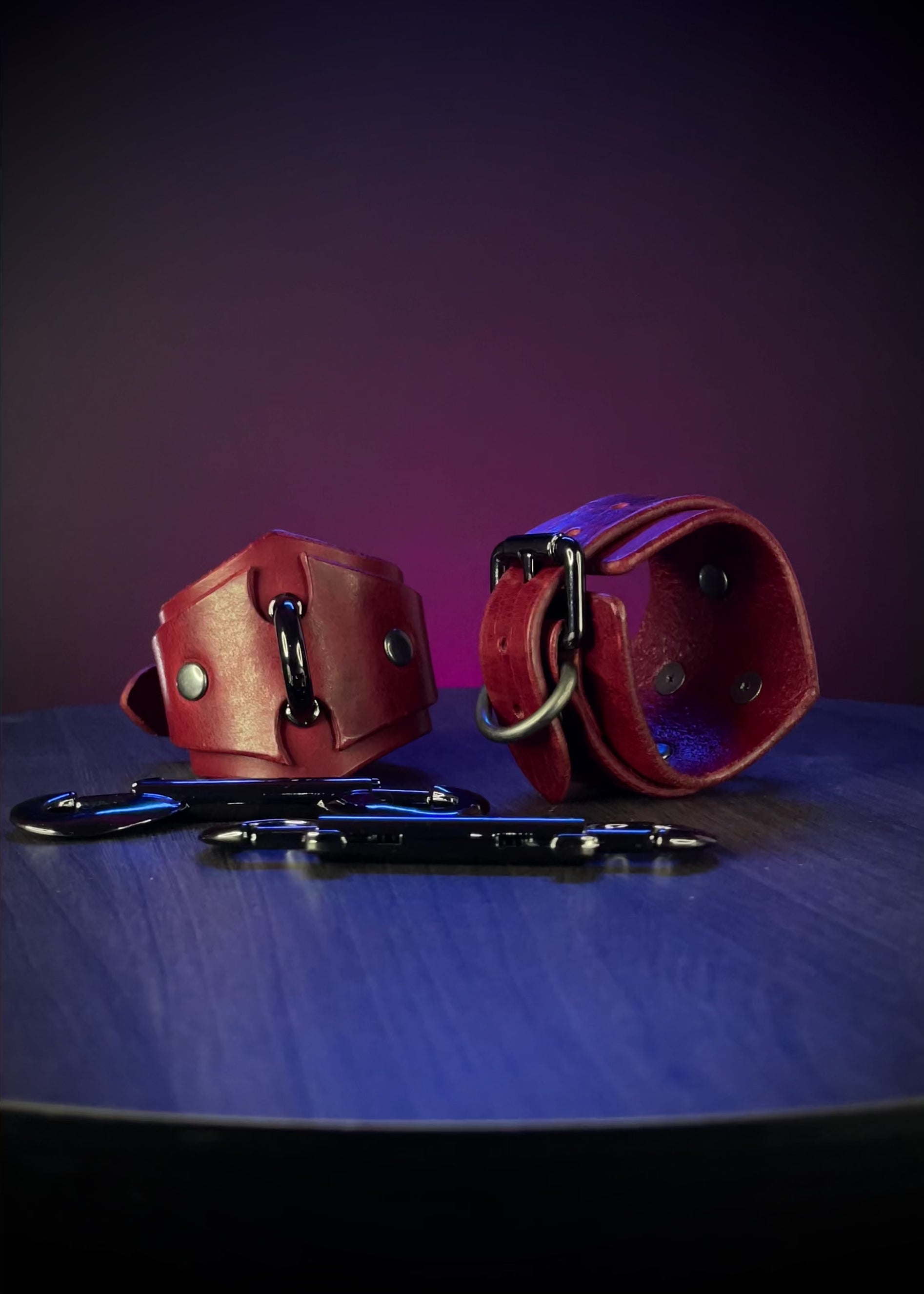 Red leather handcuffs with black hardware