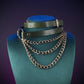 Green leather choker with gold chain and buckle worn by a person