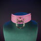 Pink leather collar on a green mannequin 